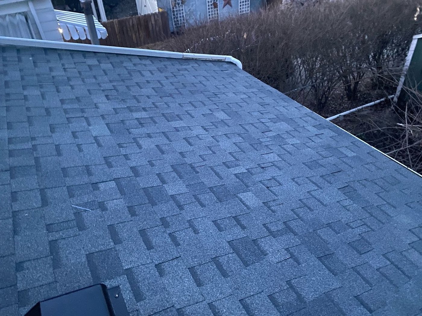 Close-up of new grey architectural shingles on a roof
